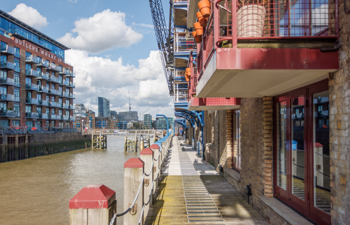 The side of a building with the doors to the PPL hub on the right and the river Necking to the left.